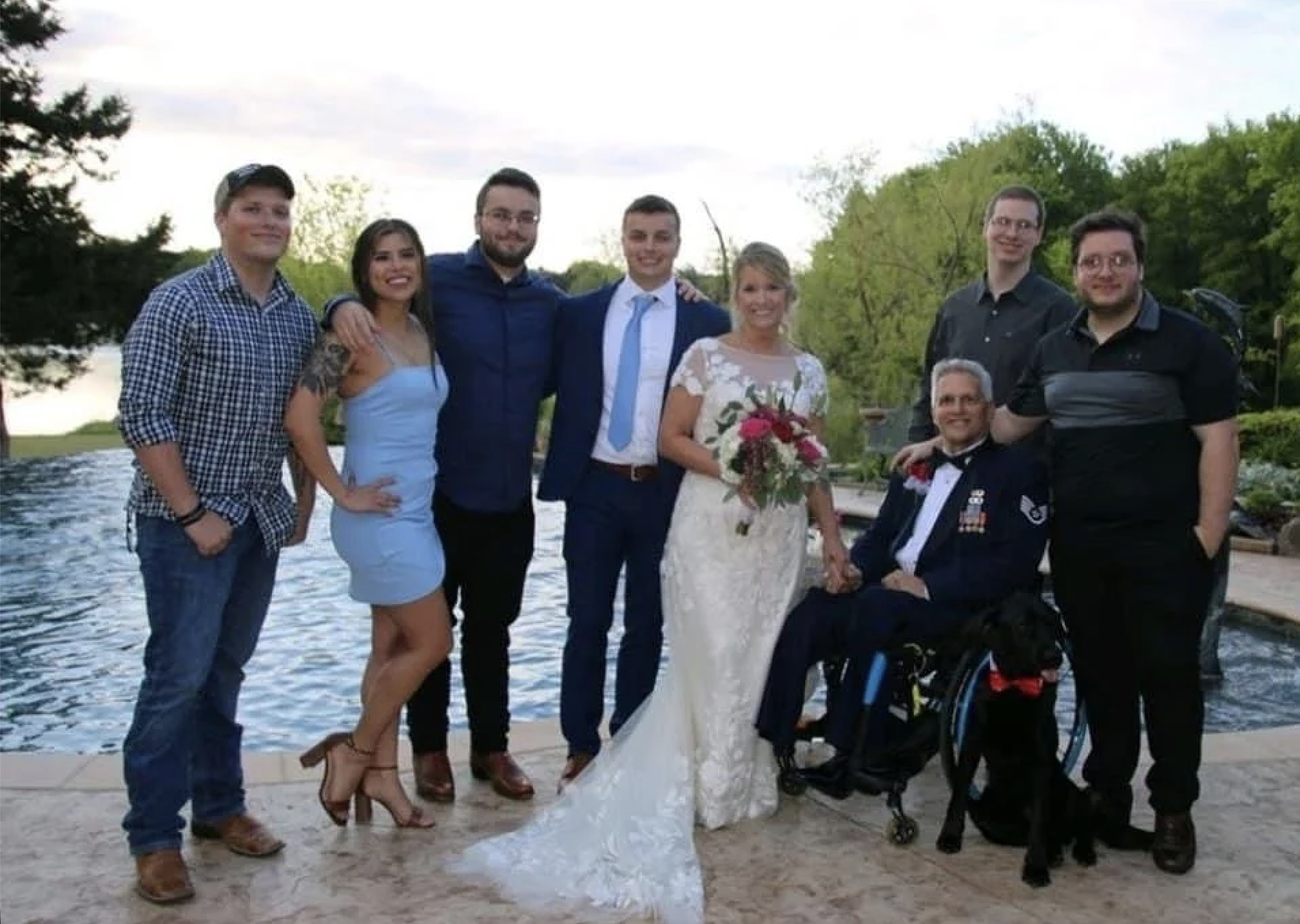 Jason Morgan with his wife Kim, service dog Yago, and their five sons at a family wedding
